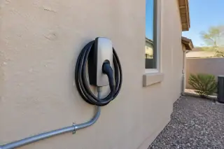 Newly mounted EV charger with conduit on a desert-facing stucco wall in Mesa, AZ.