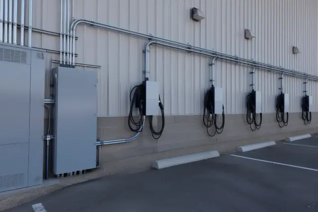 Multi-port EV charging units and conduit installed on a commercial wall in Queen Creek, AZ.