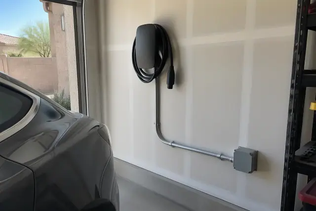 Hardwired EV charger installation on a drywall wall in San Tan Valley, AZ, with exposed conduit.