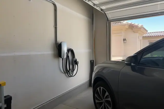 Hardwired EV charger installation on a drywall wall in a Fountain Hills, AZ garage.