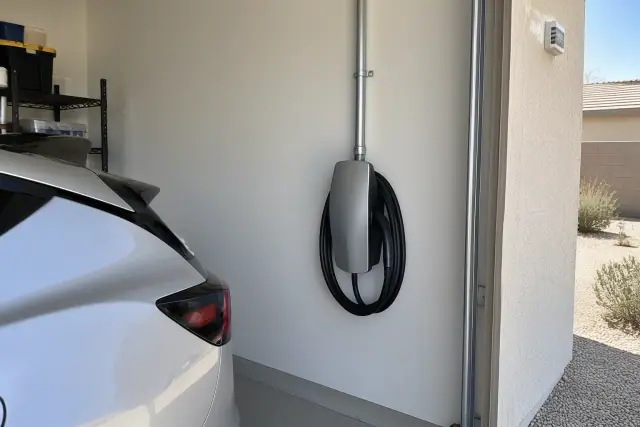 Hardwired EV charger with direct conduit entry mounted on an interior wall in Mesa, AZ.