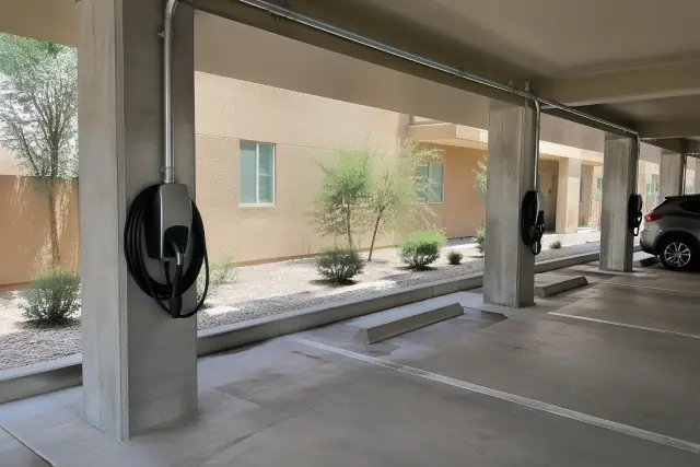 EV charger mounted on a concrete pillar with metal conduit in Gilbert, AZ.
