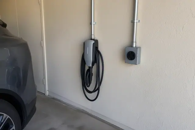 NEMA 14-50 outlet and hardwired EV charger on a garage wall in Mesa, AZ.