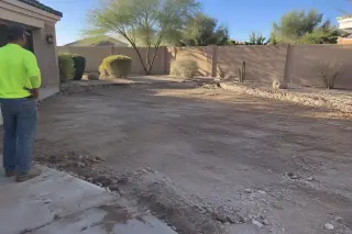 Worker observing a clean concrete removal area with exposed substrate in Mesa, AZ.