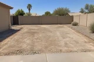 Clean cleared work area with exposed substrate and block wall in Mesa, AZ.