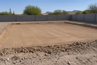 Smooth compacted earthen pad with clean finished edges and perimeter block wall in Mesa, AZ.