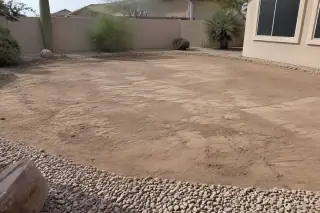Compacted soil and desert gravel filling a removed pool at a residential property in Mesa, AZ.