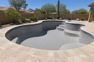 Finished concrete pool shell and surrounding coping with clean patio decking in Mesa, AZ.
