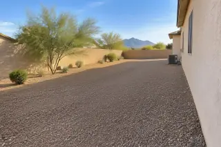 Crushed desert granite ground cover and a stucco wall at a Mesa, AZ residential property.
