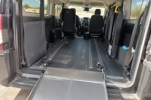 Accessible van ramp deployed inside a vehicle in Mesa, AZ, showing aluminum folding plates and floor tracks.