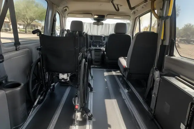 Ambulatory transportation vehicle cabin interior with secure floor tracks and overhead grab handles in Tempe, AZ.