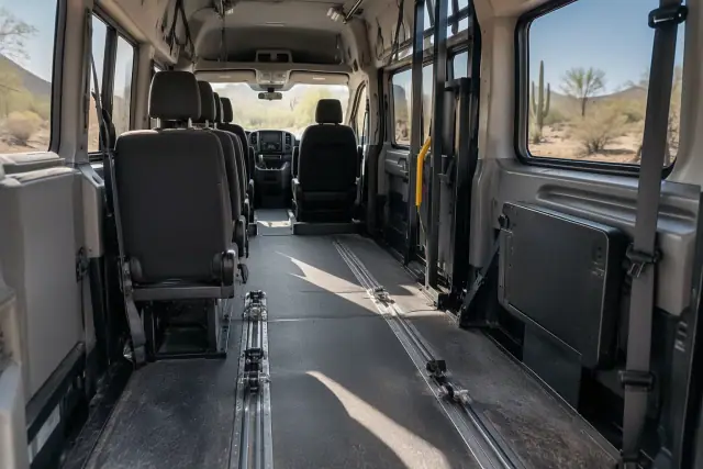 Interior cabin of a medical transport van with floor tracks and grab handles in Mesa, AZ.