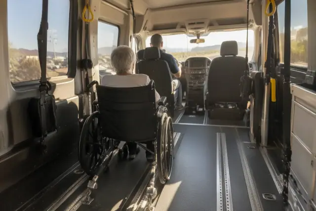 Wheelchair transport van interior in Mesa, AZ, showing floor tracks and grab handles.