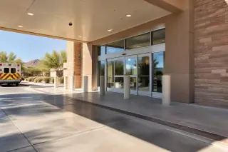 Concrete ambulance bay with sliding glass doors in Mesa, AZ.