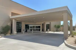 Wide view of an ambulatory transport project with a stucco exterior wall in Mesa, AZ.