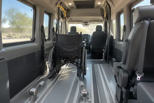 Bariatric medical transport van interior with wheelchair securement straps in Chandler, AZ.