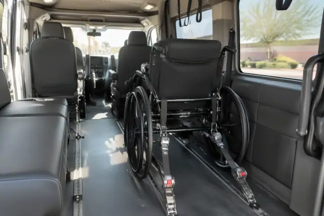 Padded interior of a bariatric transport van with heavy-duty wheelchair securement straps in Tempe, AZ.