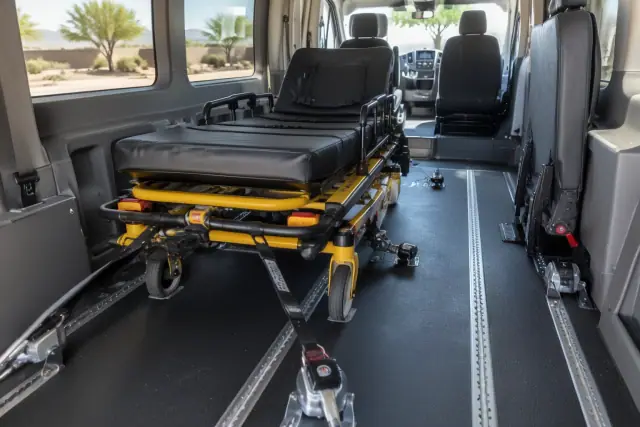 Interior of a transport van in Mesa, AZ, showing reinforced floor tracks for bariatric transportation.