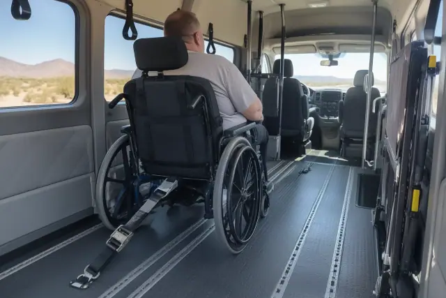 Padded interior of a medical transport van with floor tracks in Sun Lakes, AZ.