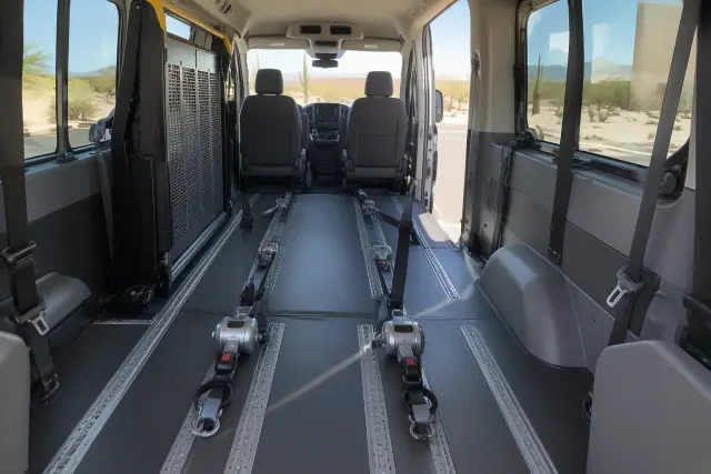 Interior of a transport van with heavy-duty floor tracks and tie-down straps in Mesa, AZ.