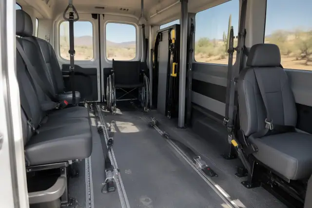 Interior of a transport van in Mesa, AZ, featuring padded seating, secure floor tracks, and unbranded restraint gear.