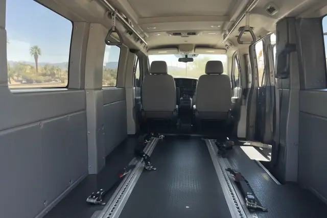 Padded interior of a behavioral health transport van with floor tracks in Mesa, AZ.