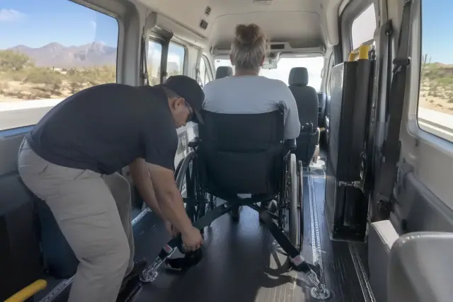 Behavioral health transport van interior in Mesa, AZ showing secure mounting hardware and desert daylight.