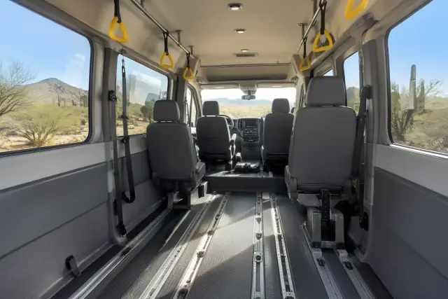 Padded transport van interior with secure floor tracks and desert views in Gold Canyon, AZ.