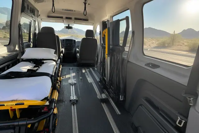 Interior of a chemotherapy transport van with secure floor tracks and grab handles in Mesa, AZ.