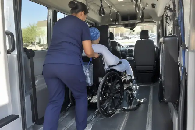Chemotherapy transportation vehicle interior with secure floor tracks and grab handles in Mesa, AZ.