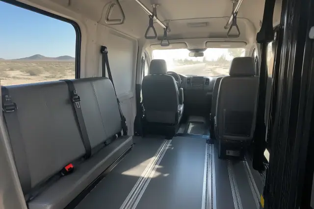 Secure floor tracks and grab handles inside a transport van in Mesa, AZ.