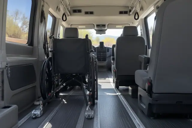 Padded interior of a medical transport van with secure floor tracks in San Tan Valley, AZ.