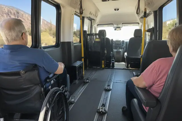 Dialysis transportation van interior with padded seating and floor tracks in Tempe, AZ.
