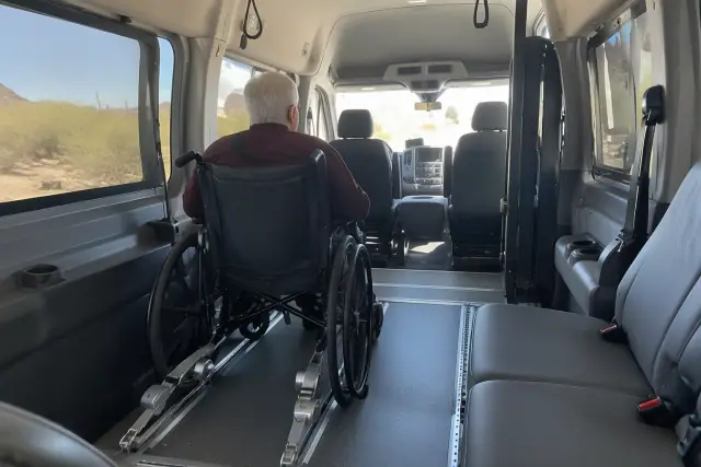 Padded interior of a medical transport van with floor tracks in Gold Canyon, AZ.