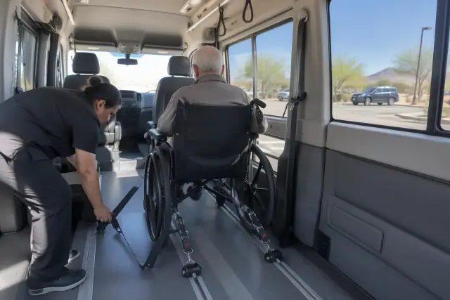 Dialysis transportation van interior with wheelchair securement straps in Mesa, AZ.