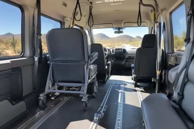 Interior of a dialysis transportation vehicle with secure floor tracks and overhead grab handles in Mesa, AZ.