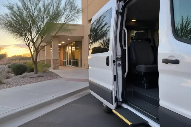 Transport van parked outside an outpatient oncology office at dawn in Mesa, AZ.