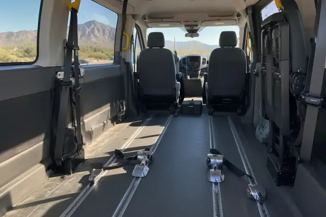 Interior of a medical transport van with floor tracks and a desert view in Apache Junction, AZ.