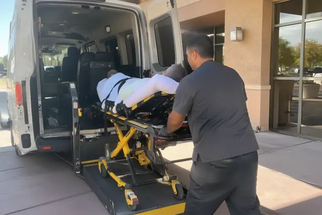 Hospital discharge transportation vehicle parked outside a stucco building in Mesa, AZ.