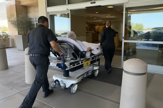Hospital discharge stretcher transportation at a hospital loading bay in Mesa, AZ.