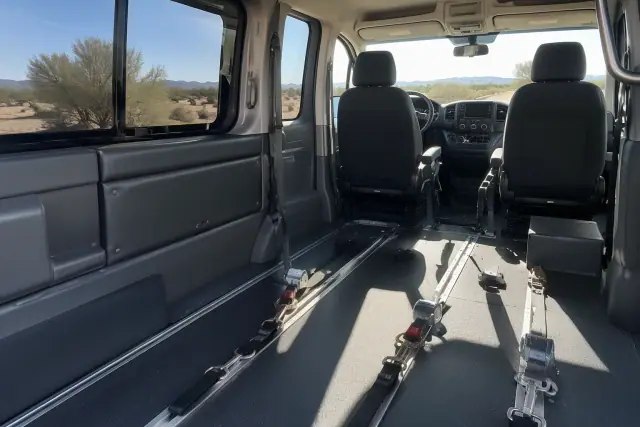Hospital discharge transportation van interior with floor tie-down straps in Queen Creek, AZ.