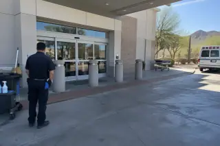 Technician observing a concrete ambulance bay with bollards in Mesa, AZ.