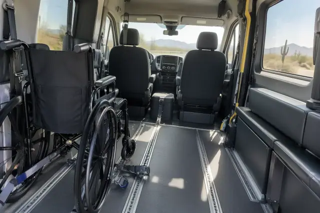 Driver's photo of a transport van interior with padded features and floor tracks in Mesa, AZ.