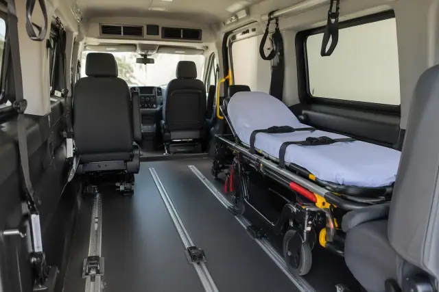 Padded medical transport van interior with secure floor tracks in Apache Junction, AZ.
