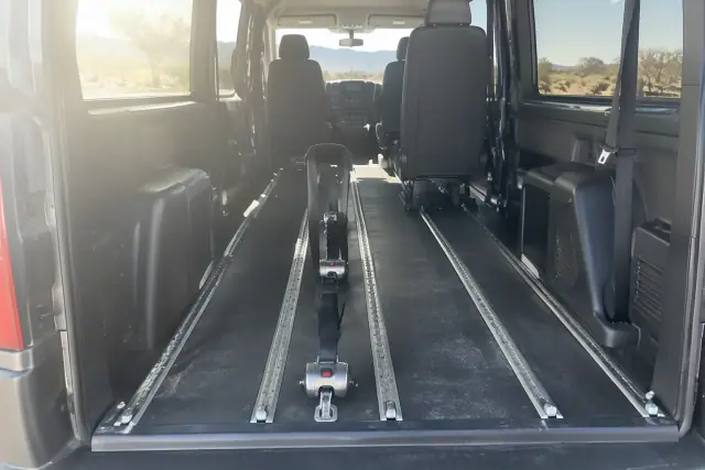 Heavy-duty floor tracks and a wheelchair lockdown clamp for medical transport in Mesa, AZ.