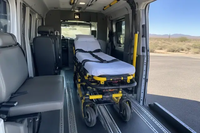 Interior of a medical transport van with secure floor tracks and padded cabin in Mesa, AZ.