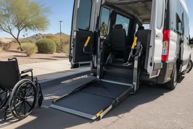 Ambulatory medical transport vehicle with loading ramp and tie-downs outside in Mesa, AZ.