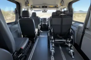 Padded vehicle interior with secure floor tracks and desert daylight through windows in Mesa, AZ.