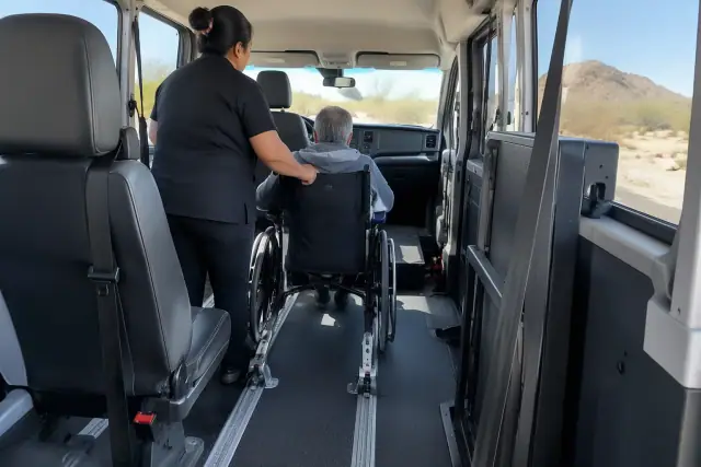 Interior cabin of a transport van with padded seating and floor tracks in Mesa, AZ.