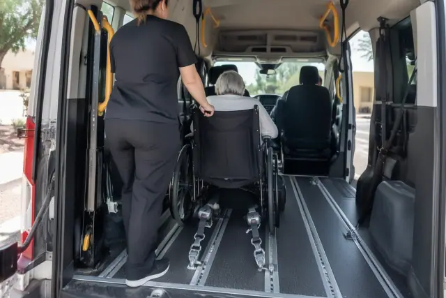 Wheelchair accessible van interior with secure floor tracks and grab handles for medical appointment transportation in Mesa